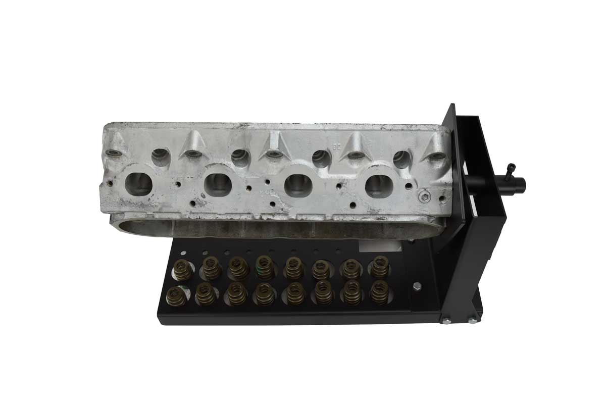 Rotating cylinder head stand with mounting plate with cylinder head attached and valves stored